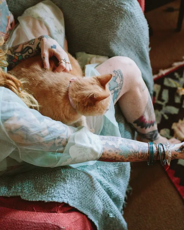 Woman relaxing with her orange cat